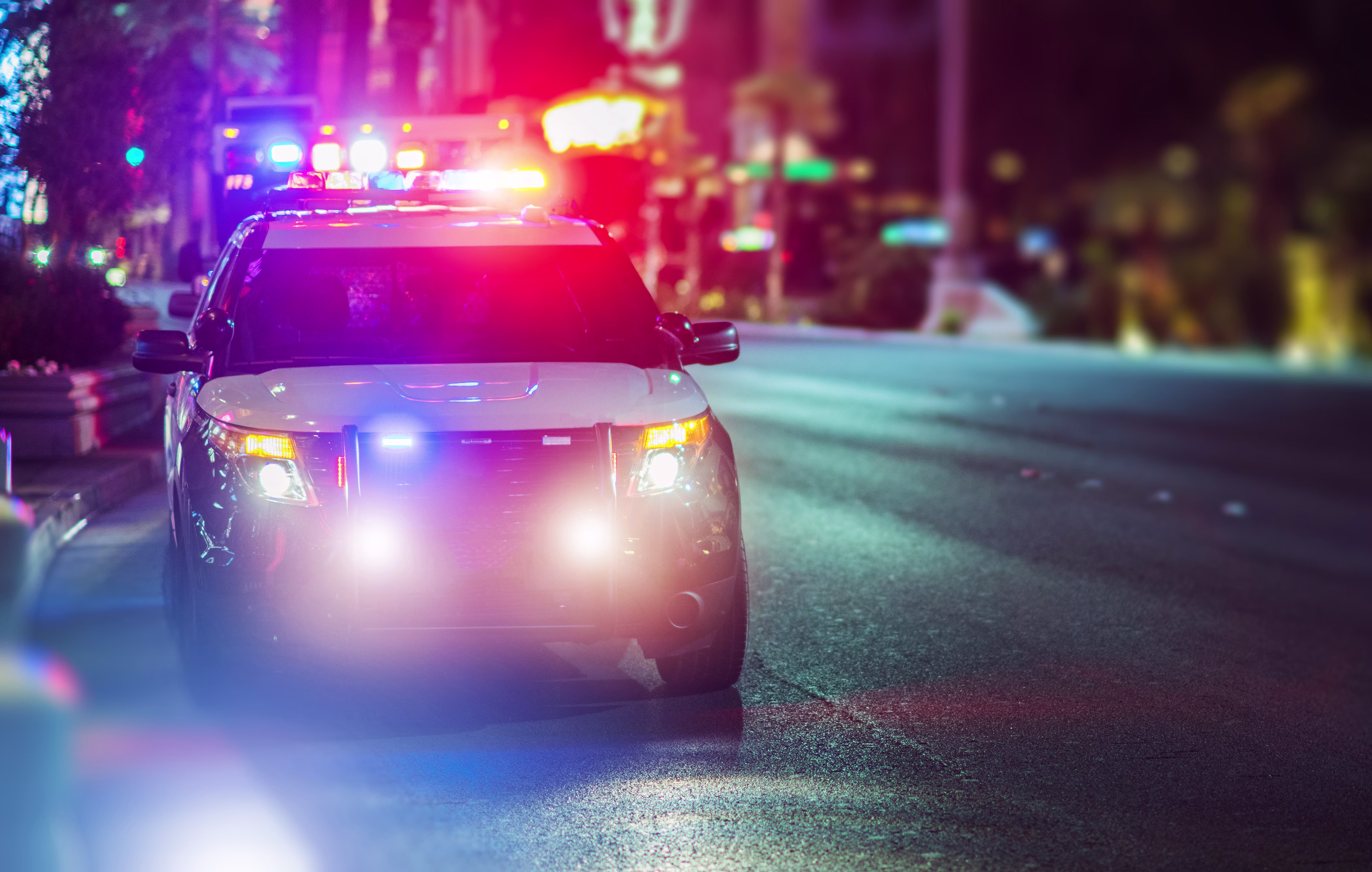 Police car with lights flashing at night