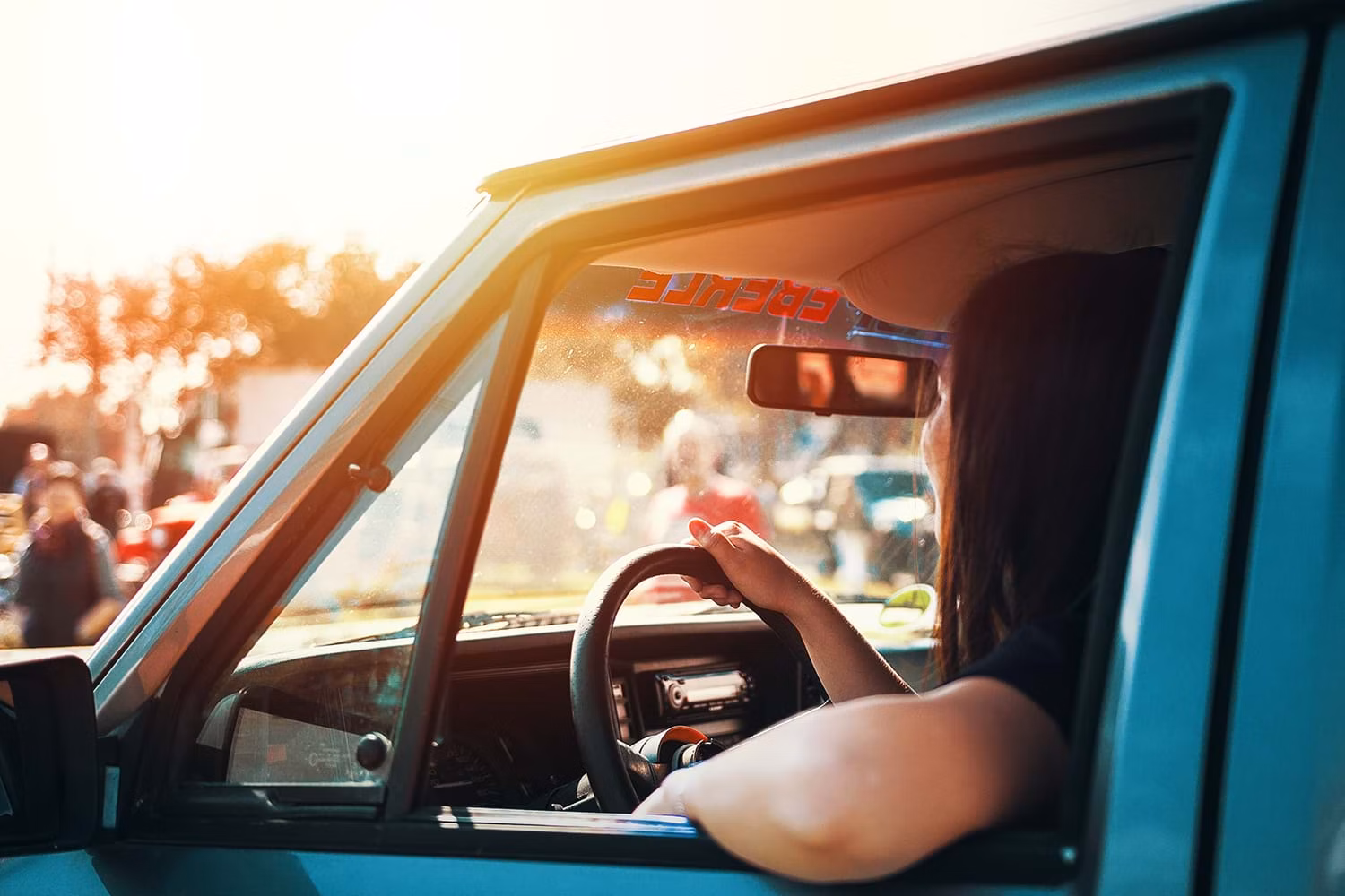 Woman driving truck in glaring sun