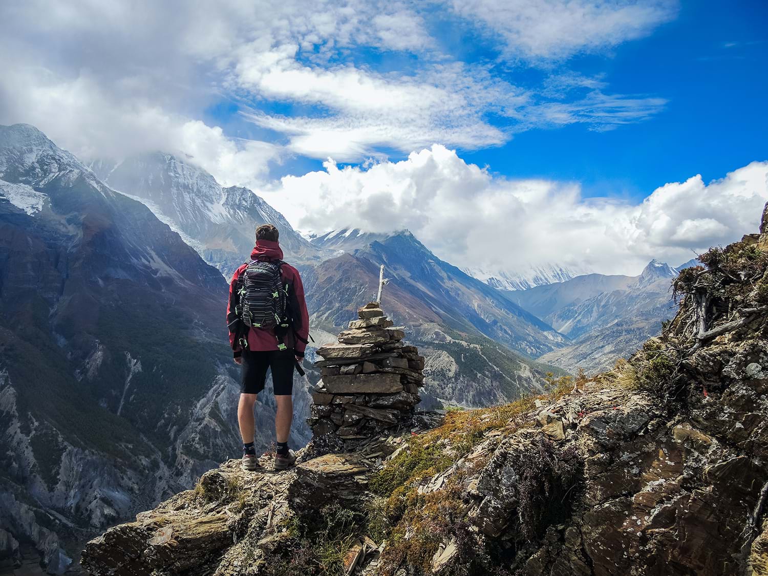Hiker on side of mountain looking at view
