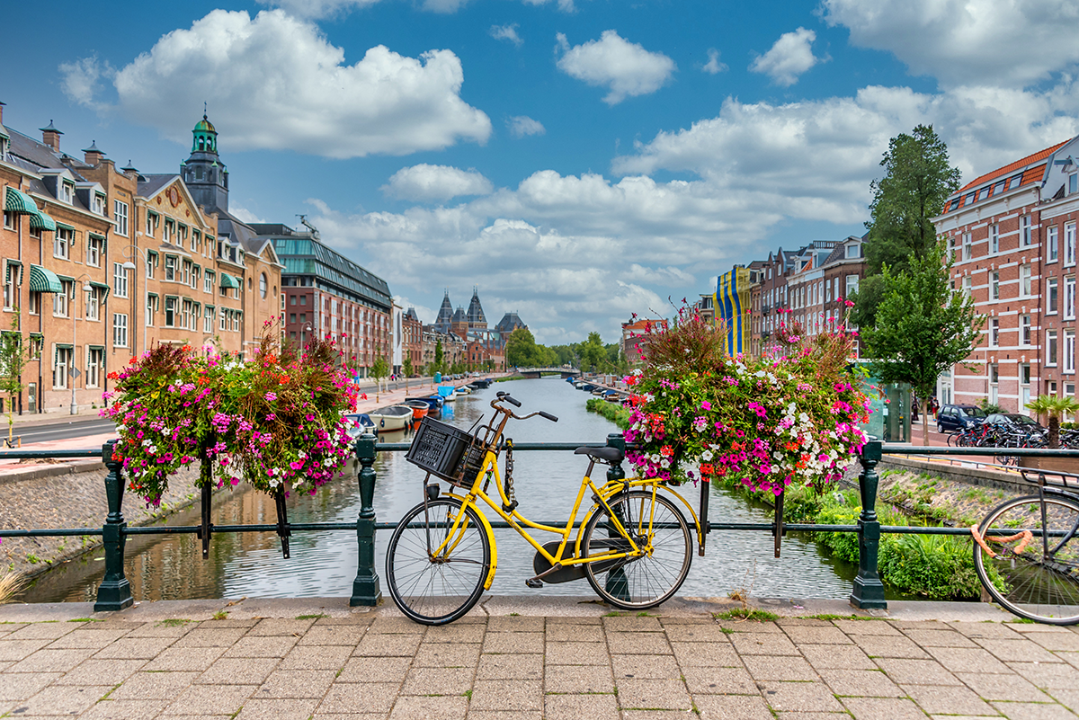 Bike on bridge over canal in Amsterdam